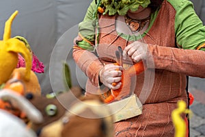 Woman handmade soft felted toys in front of viewers.