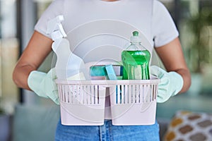 Woman, hands and basket for cleaning and housework with cleaning products for living room clean. Hygiene, cleaning