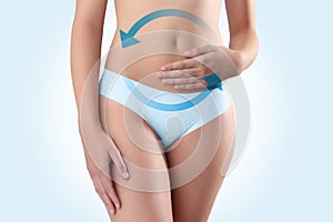 Woman hands on belly with blue arrow photo