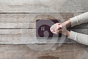 Woman hands on bible