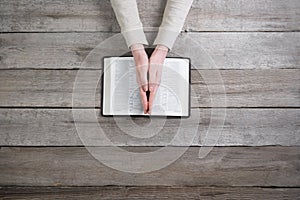 Woman hands on bible. she is reading and praying