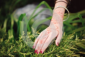 Woman Hands with black mehndi tattoo. Hands of Indian bride girl with black henna tattoos. Fashion. India