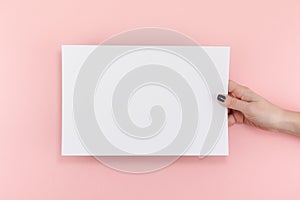 Woman hands with blank A4 paper sheet mockup