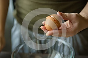 Woman hands breaking egg