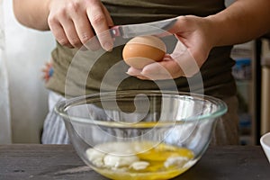 Woman hands breaking egg