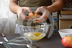 Woman hands breaking egg