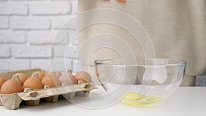 Woman hands breaking an egg, preparing to make dough