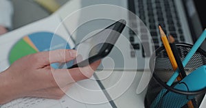 Woman hands browsing the internet using smartphone, scrolls through her news. Girl using mobile phone app and messaging