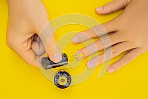 Woman Hands Care. Top View Of Beautiful Smooth Woman`s Hands With Professional Nail Care Tools For Manicure On yellow