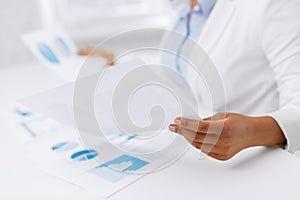 Woman hands with charts and papers