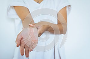 Woman hands checking her pulse with two fingers on wrist