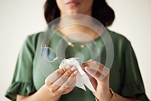 Woman, hands and clean the dust on glasses for heathy vision with cloth for protection. Eye, care and wipe spectacles