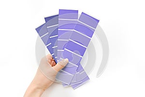 Woman hands with color card on white background, violet color very peri