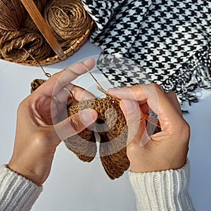 woman hands is crocheting