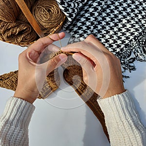 woman hands is crocheting