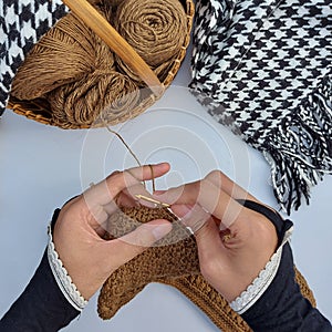 woman hands is crocheting