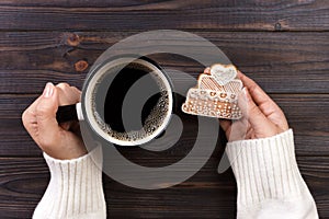 woman hands with cup of coffee with cookies