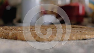 Woman hands cutting cookies on whole wheat dough on floured countertop