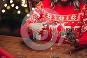 Woman hands cutting jute twine