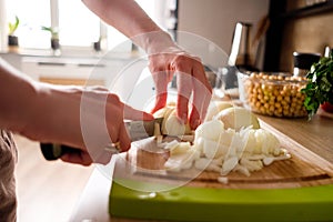 Woman hands, cutting onions