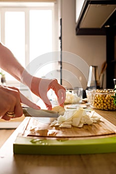 Woman hands, cutting onions