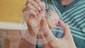 Woman hands decorating Easter eggs