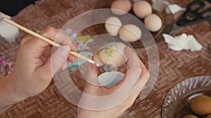 Woman hands decorating Easter eggs