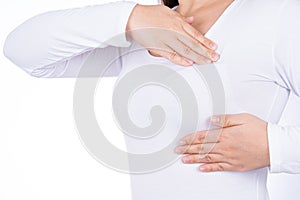 Woman hands doing breast self exam for checking lumps and signs of breast cancer isolated over white background. Medical,