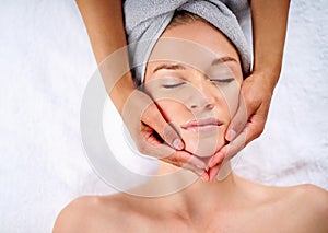 Woman, hands and facial massage or pamper treatment, cosmetics and beauty therapy. Female person, masseuse and serene or photo