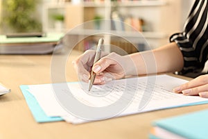 Woman hands filling out form working at home