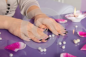 Woman hands with french manicure with crystals