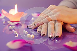 Woman hands with french manicure with crystals