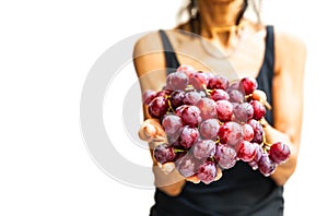 Woman hands with fresh red grapes