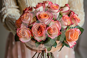 woman hands gently holding a lavish bouquet of roses