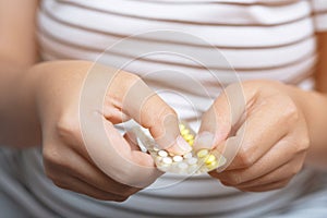 Woman hands give birth control pills in hand. Taking Contraceptive Pill.