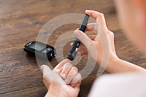Woman Hands With Glucometer photo