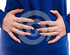 Woman hands grabbing bloated abdomen