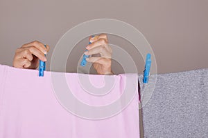 Woman Hands Hanging Wet Clean Cloth To Dry On Clothes Line At La