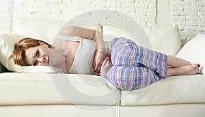 Woman with hands on her belly or tummy suffering stomach cramp and period pain