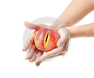 Woman hands hold peach with cute slice on white. Concept of intimate female part