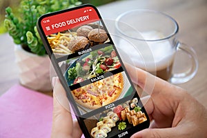 woman hands hold phone with food delivery app in ?afe