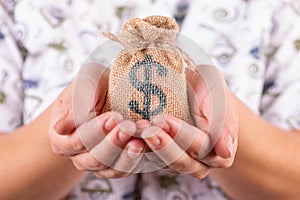 woman hands hold sack bag with dollar sign close up