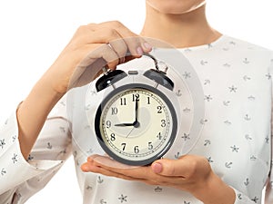 Woman hands holding black alarm clock
