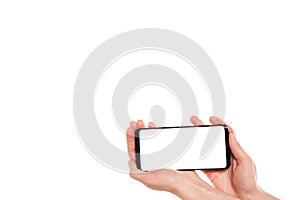 Woman hands holding the black smartphone blank screen with modern frameless design isolated on white background