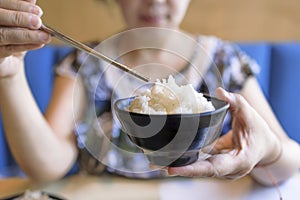 Woman hands holding Bowl of tasty cooked white rice