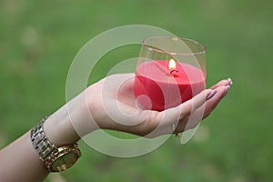 Woman hands holding a candle, sign of hope concept