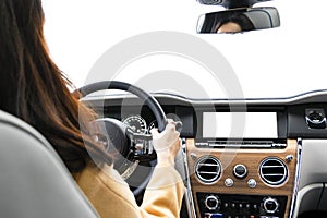 Woman hands holding car steering wheel of a modern car. Hands on steering wheel of a car driving. Girl driving a car inside cabin.