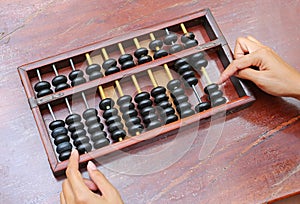 Woman hands holding Chinese ABACUS old antique calculator retro finance education, tool work business accounting