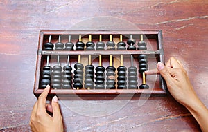 Woman hands holding Chinese ABACUS old antique calculator retro finance education, tool work business accounting