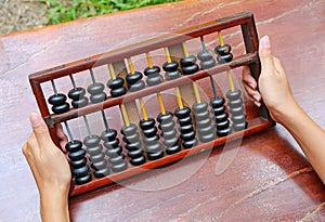 Woman hands holding Chinese ABACUS old antique calculator retro finance education, tool work business accounting